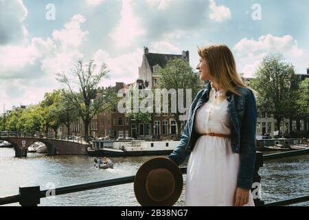 Woman overlooking canal city scape Stock Photo