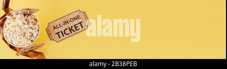 Movie tickets, film strips and popcorn on blue background. Copy space for text Stock Photo