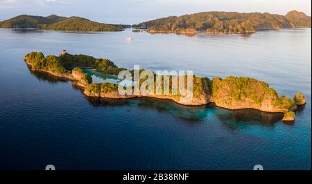 The beautiful rock islands found in Raja Ampat, Indonesia, are ancient coral reefs that were uplifted by tectonic events millions of years ago. Stock Photo