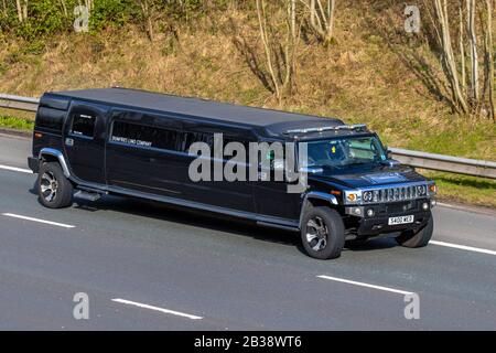 2008 American black Hummer H2 Auto stretch limo; Dumfries Limo Company; Vehicular traffic, USA transport, modern vehicles, hire cars, vehicle on UK roads, motors, motoring on the M6 motorway Stock Photo