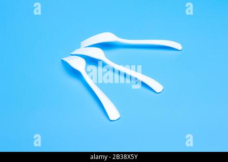 plastic tableware for picnics, parties and informal meals. White plastic disposable holders for use and disposal. Stock Photo
