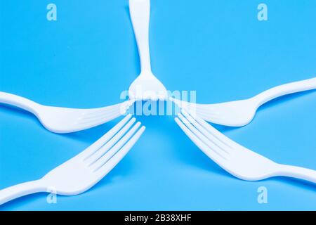 plastic tableware for picnics, parties and informal meals. White plastic disposable holders for use and disposal. Stock Photo