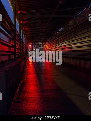 Abstracts of metropolitan street with crossroads and red traffic lights. Stock Photo