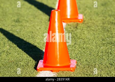 Orange cones on a green turf field up close Stock Photo