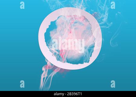 Abstract soft pink color paint smoke explosion with round frame on blue background. Creative minimal design composition with copy space Stock Photo
