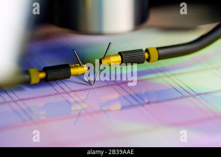 Manual probe system with needles for test of semiconductor on silicon wafer. Selective focus. Stock Photo