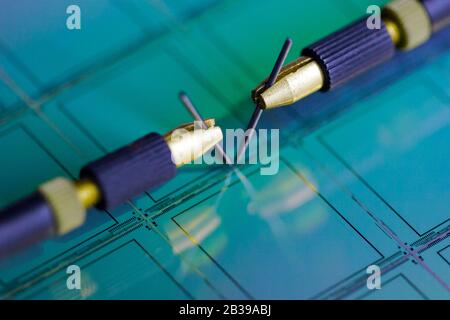 Manual probe system with needles for test of semiconductor on silicon wafer. Selective focus. Stock Photo