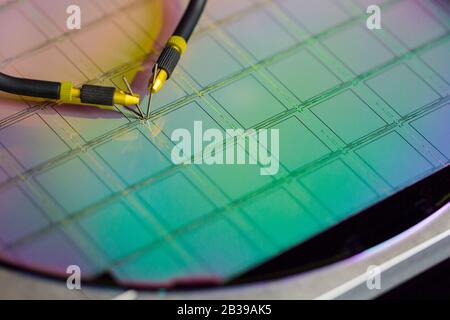 Manual probe system with needles for test of semiconductor on silicon wafer. Selective focus. Stock Photo