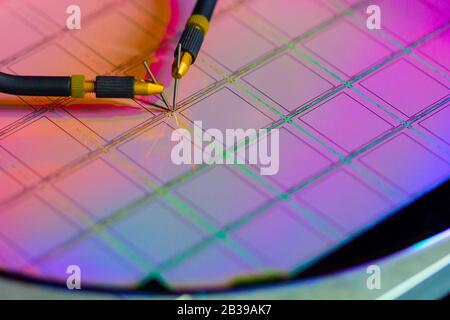 Checking microchips on silicon wafer with probe station.Close up . Semiconductor Crystal Manufacturing.Selective focus. Stock Photo
