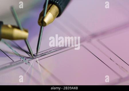 Manual probe system with needles for test of semiconductor on silicon wafer. Selective focus. Stock Photo