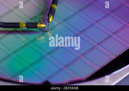 Manual probe system with needles for test of semiconductor on silicon wafer. Selective focus. Stock Photo