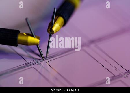 Manual probe system with needles for test of semiconductor on silicon wafer. Selective focus. Stock Photo