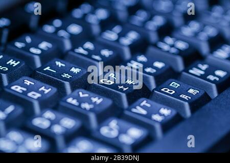Black keyboard with multi languages. Selective focus. Stock Photo