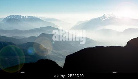 Spectacular view of mountain ranges silhouettes and fog in valleys. Stock Photo