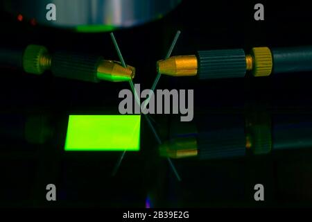 Close up of examining a sample of OLED display with probe station under the microscope in laboratory.A semiconductor on a silicon wafer. Selective Stock Photo