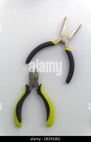 pair of old pliers with rust and dirty stain, old pliers with rust and dirty stain, isolated mechanical tool, old pliers tool with yellow grips on Stock Photo