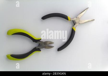 pair of old pliers with rust and dirty stain, old pliers with rust and dirty stain, isolated mechanical tool, old pliers tool with yellow grips on Stock Photo
