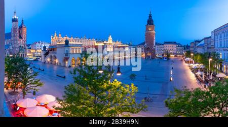 Aerial panorama of Medieval Main market square with Cloth Hall and Town Hall Tower in Old Town of Krakow at night, Poland