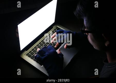 hacker stealing data laptop at night , closeup  Stock Photo