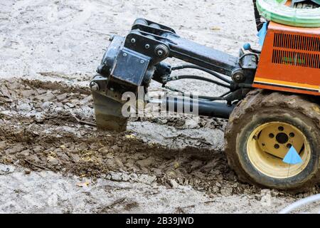 Digging a pipe in the workers installing irrigation for water plants with automatic watering system. Stock Photo