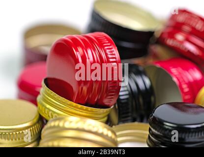 Old aluminum bottle caps against a white background Stock Photo