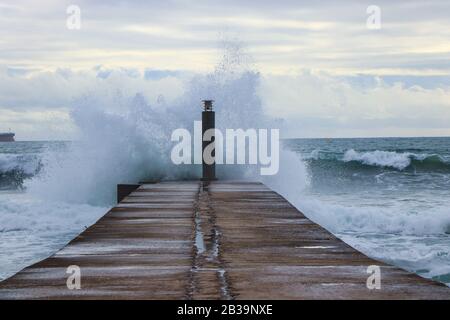 Big ocean wave hit in a jetty in a stormy day Stock Photo
