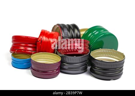 Old aluminum bottle caps against a white background Stock Photo