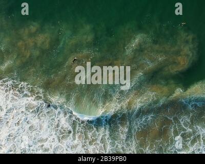 aerial view from a big wave crashing in a beach. Drone view Stock Photo