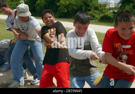 Austin Texas USA, circa 2004: Sixth-grade boys compete in a tug of war during annual Track and Field day at Walnut Creek Elementary School.   ©Bob Daemmrich Stock Photo