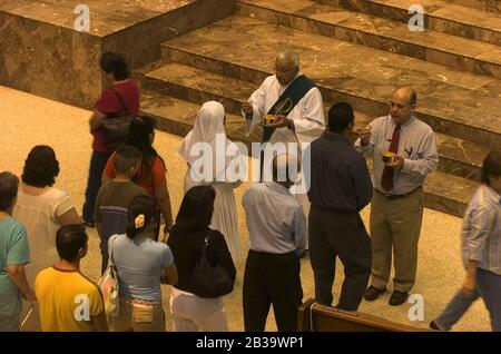 San Juan Texas USA, circa 2004: Catholics receive communion during service at the Basilica of Our Lady of Del Valle, San Juan, Texas. ©Bob Daemmrich Stock Photo