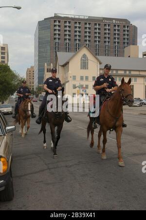 Austin Texas USA, circa 2004: Police officers patrol downtown on horseback. ©Bob Daemmrich Stock Photo