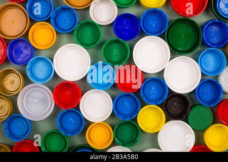 A lot of multi-colored caps from plastic bottles for recycling. Zero waste concept layout. Stock Photo