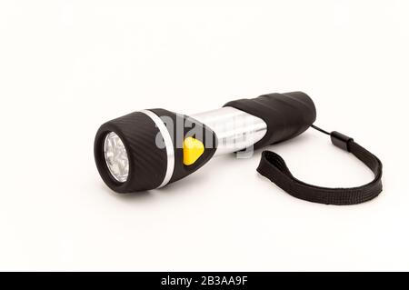 Electric black torch with an orange switch isolate on a black background Stock Photo
