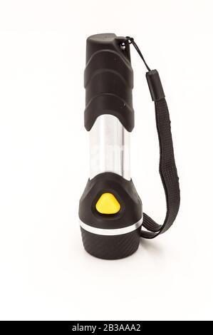 Electric black torch with an orange switch isolate on a black background Stock Photo