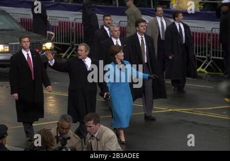 Washington, D.C. USA, Jan. 20, 2001: Newly inaugurated Pres. George W. Bush and First Lady Laura Bush wave to spectators as they walk on Pennsylvania Avenue during the inauguration parade. ©Bob Daemmrich Stock Photo
