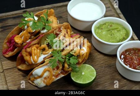 Mexican tacos on a wood board Stock Photo
