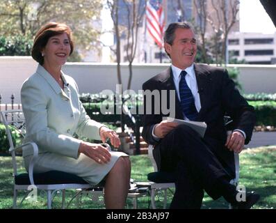 Austin, Texas USA, 02 MAR 99: Texas Gov. George W. Bush and First Lady Laura Bush  laugh at a question from the Texas media at the Governor's Mansion as Gov. Bush announces at a press conference that he plans to run for president. ©Bob Daemmrich Stock Photo