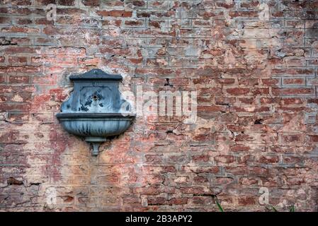 Antique drinking fountain - sprue - spout on a train station Stock Photo