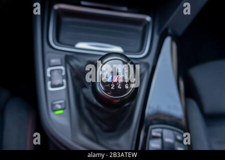 Inside car dashboard view.Detailed close-up photo of manual transmission knob/lever in neutral position.Leather upholstery,6 gear transmission/reverse Stock Photo