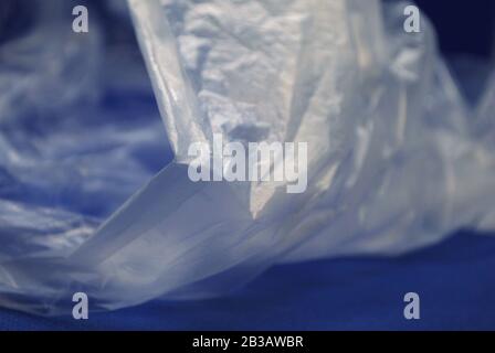 Close up view of transparent polyethylene plastic bag from on a blue background