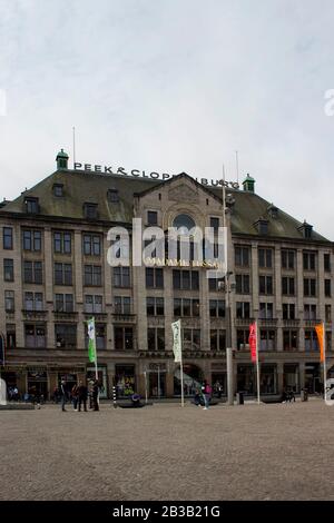 View of people hanging out at Dam square in Amsterdam. Madame Tussaud is in the background. Stock Photo