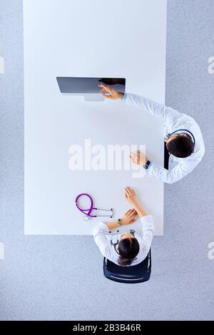 Doctors in the office talking and showing something on the monitor screen. Medical concept Stock Photo