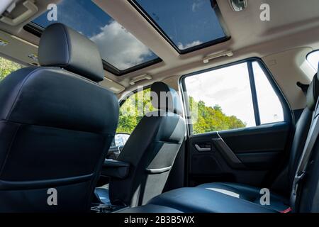 Panoramic roof - double sunroof in a luxurious suv car, glazed dach glass, blue tinted windows, and leather upholstery. Inside a luxurious SUV