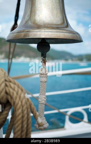 Brass ship's bell detail from Norwegian Tallship Christian Radich docked in Philipsburg, Sint Maarten, January 2013. Select focus on bell pull. Stock Photo