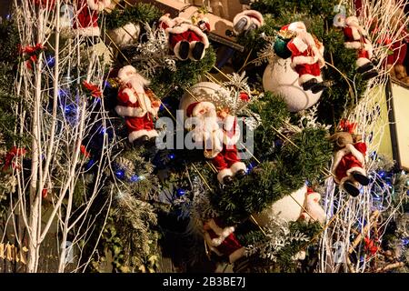 Festive winter tree decorations featuring golden mesh ribbons, glitter  globes, large silk poinsettia flowers, seasonal ornaments for Christmas  tree Stock Photo - Alamy