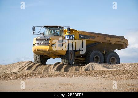 Hayling Island,Hampshire. Earth moving machinery is used to move beach gravel from West to East each year to counteract the effect of longshore drift Stock Photo