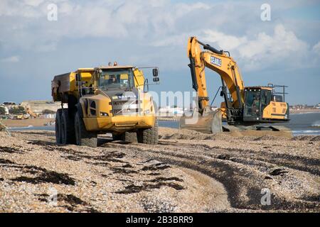 Hayling Island,Hampshire. Earth moving machinery is used to move beach gravel from West to East each year to counteract the effect of longshore drift Stock Photo