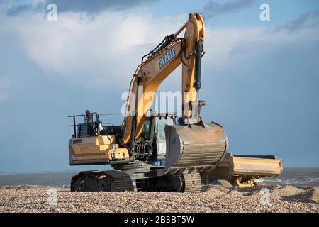 Hayling Island,Hampshire. Earth moving machinery is used to move beach gravel from West to East each year to counteract the effect of longshore drift Stock Photo