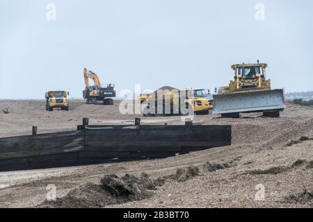Hayling Island,Hampshire. Earth moving machinery is used to move beach gravel from West to East each year to counteract the effect of longshore drift Stock Photo