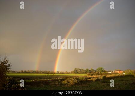 Double rainbow over fields. Hayling Island, Hampshire Stock Photo